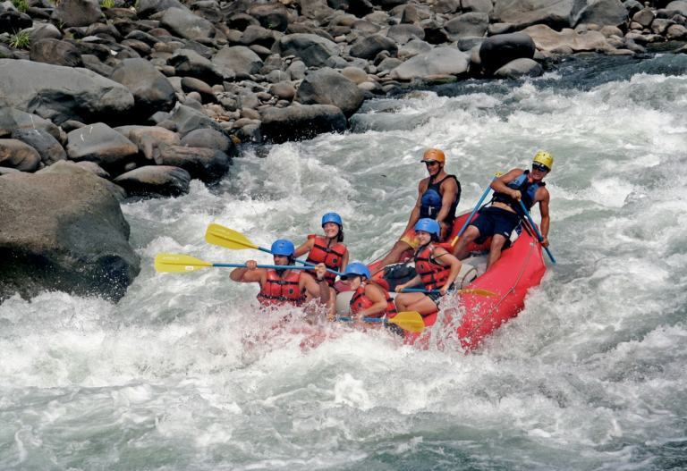 Group paddling a raft on a river in Costa Rica
