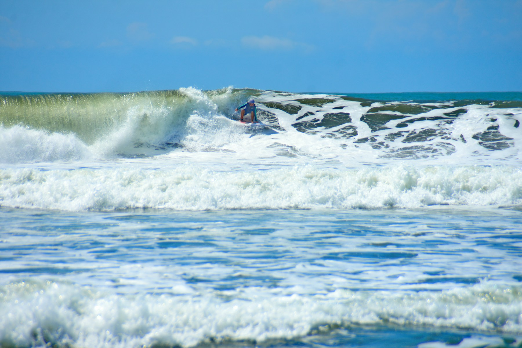 Surfer riding a breaking wave; surfing activity illustration