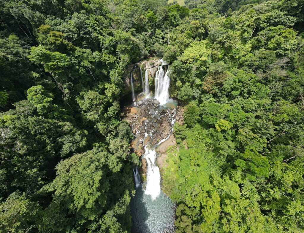 Two tiers of Nauyaca Waterfalls surrounded by Costa Rican rainforest